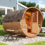 Backyard wooden barrel sauna, an outdoor round cabin used for hot spring vacations, thermotherapy, steam experiences, and traditional sauna indoors